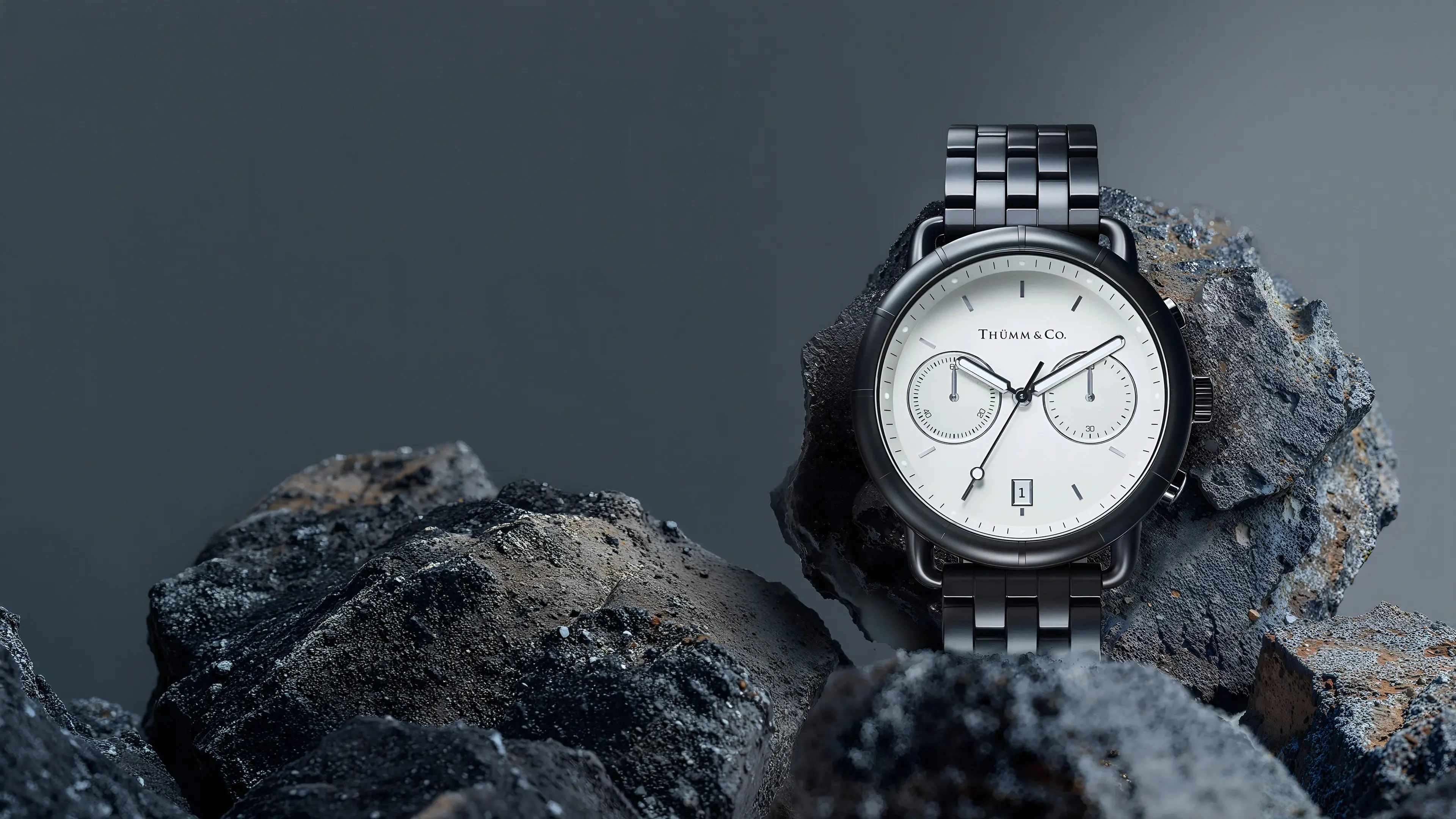 Luxury chronograph watch with a white dial and dark metal bracelet rendered in 3D resting on dark rocks