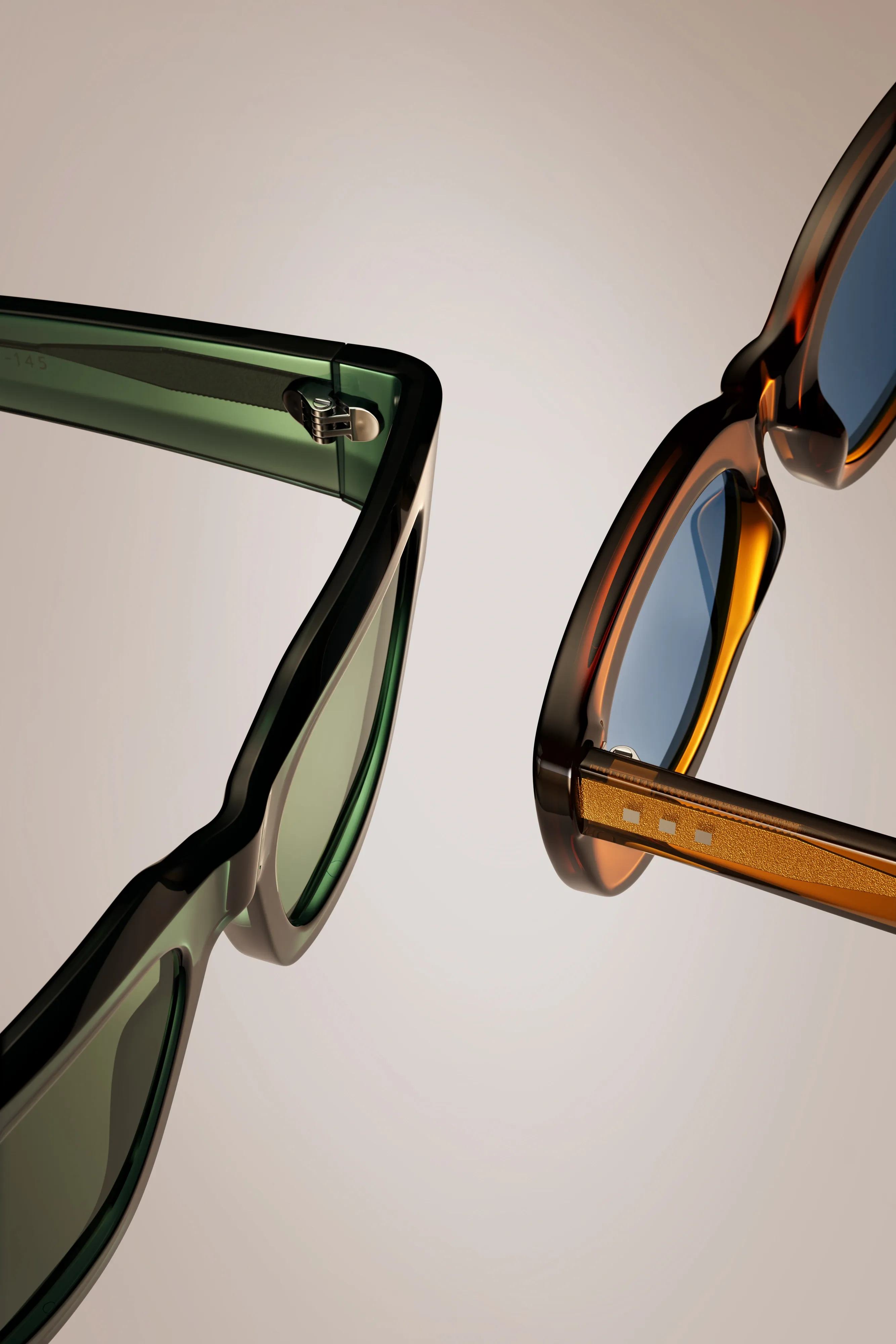 Close-up of green and amber Monos sunglasses frames and hinges