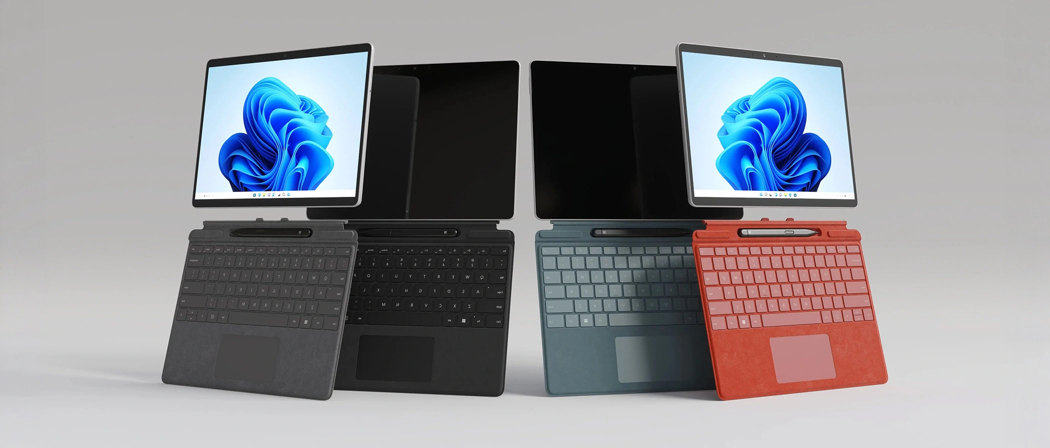 A full lineup of four 2-in-1 laptops in different color finishes arranged as a group shot