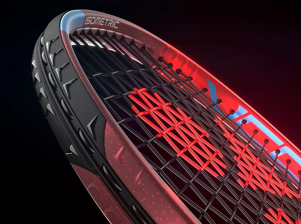 Close-up of a red and black tennis racket head on a dramatic black background